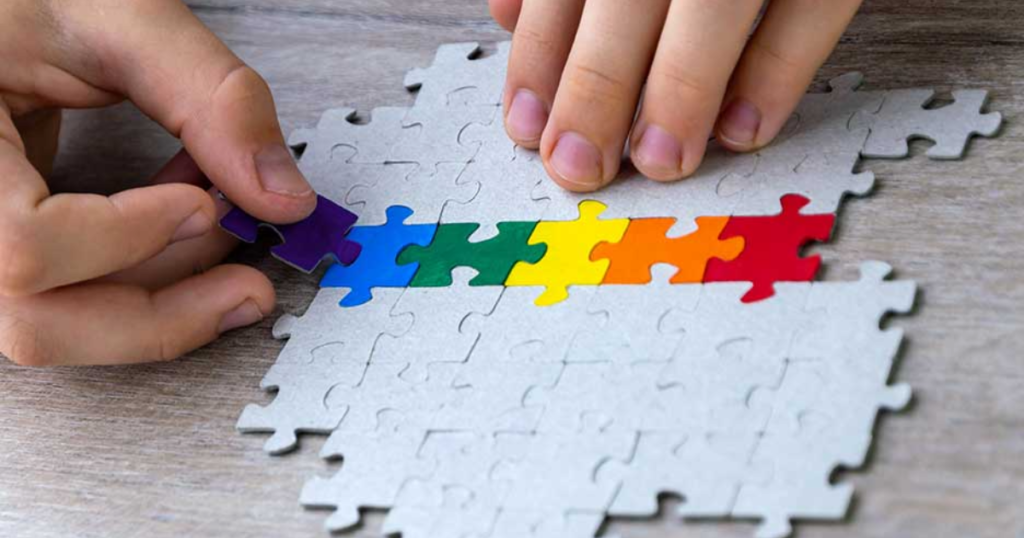 A student builds a LGBT pride flag of the puzzle